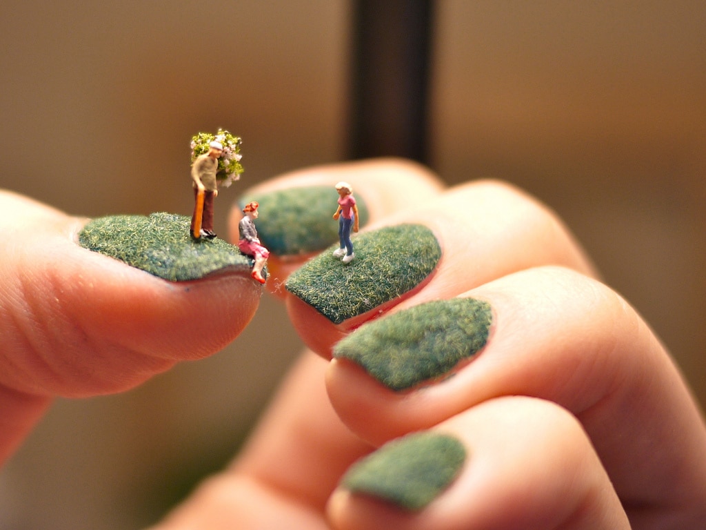 A World Of Miniature People Living On Green Fingernails